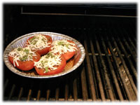 cooking baked tomatoes on the BBQ 
