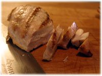 slicing a grilled chicken breast 