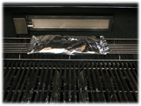 foil wrapped squash on upper grill rack