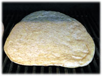 pizza dough on the grill 