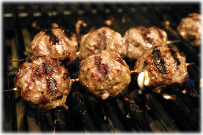 grilling meatballs on a skewer