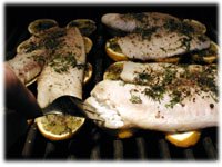 tilapia and fresh lemons on the grill